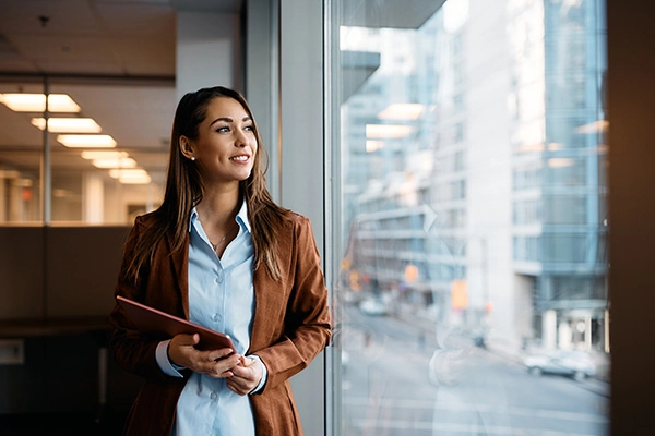 Businesswoman reviewing charts on a tablet, depicting modern accounting services for small businesses.