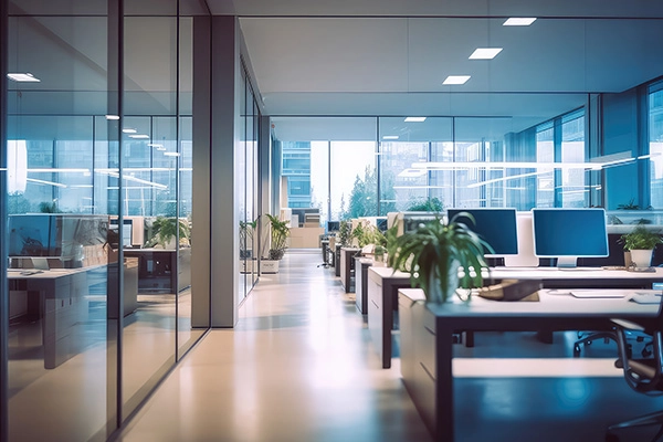 Modern real estate office interior featuring bright natural light from large windows representing real estate accounting.
