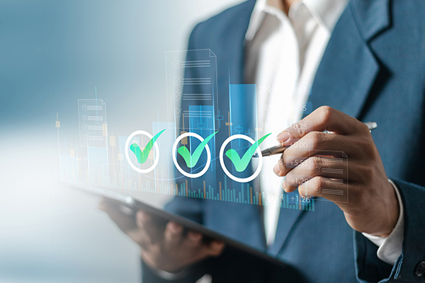 Person in a suit using a tablet to review FDICIA and SOX controls indicators.